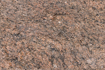 Seamless photo of a red gray granite surface speckled with black mineral flecks