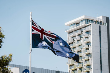 A beautiful blue Australian flag waving in the wind outdoor at daytime during winter with blue sky in Adelaide city centre in South Australia.