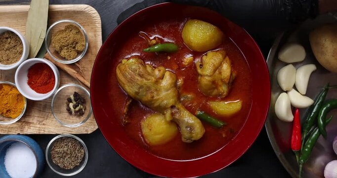 Bengali style spicy chicken curry stew with potato leg piece recipe ingredients tomato ginger gallic onion cumin coriander garam masala salt turmeric chili