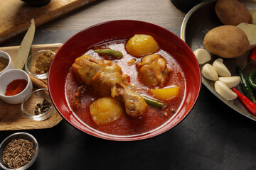 Bengali style spicy chicken curry stew with potato leg piece recipe ingredients tomato ginger gallic onion cumin coriander garam masala salt turmeric chili