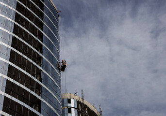 Construction worker on a suspended cradle