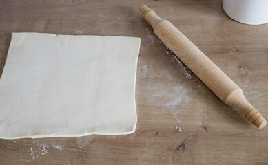 rolling pin and flour on wooden background.