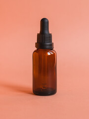 Different serum cosmetic bottles, white and dark brown dropper bottle container and packaging skincare product. studio pastel light background.