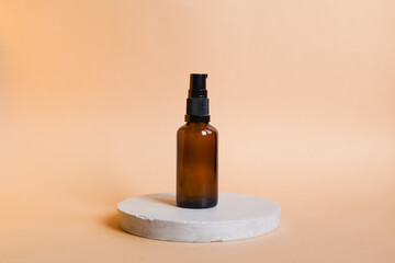 Different serum cosmetic bottles, white and dark brown dropper bottle container and packaging skincare product. studio pastel light background.