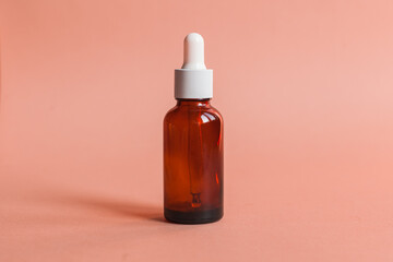Different serum cosmetic bottles, white and dark brown dropper bottle container and packaging skincare product. studio pastel light background.