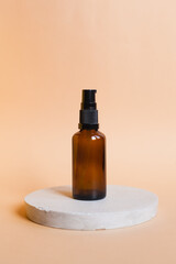 Different serum cosmetic bottles, white and dark brown dropper bottle container and packaging skincare product. studio pastel light background.