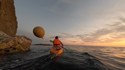 Man kayaking calm sea, ocean adventure, sunset, scenic coastal journey, serene watersport activity