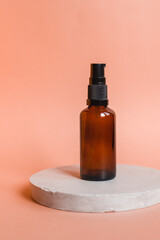 Different serum cosmetic bottles, white and dark brown dropper bottle container and packaging skincare product. studio pastel light background.