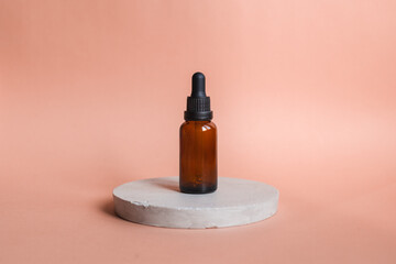 Different serum cosmetic bottles, white and dark brown dropper bottle container and packaging skincare product. studio pastel light background.