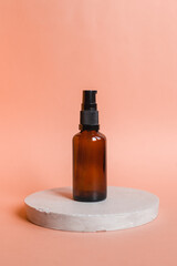 Different serum cosmetic bottles, white and dark brown dropper bottle container and packaging skincare product. studio pastel light background.