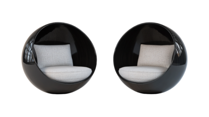 Two modern black cocoon chairs with soft cushions isolated on black background