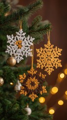 three white snowflake ornaments with a yellow star in the middle, hanging on a christmas tree