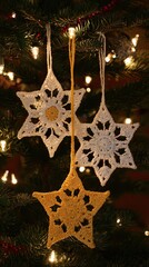 three white snowflake ornaments with a yellow star in the middle, hanging on a christmas tree