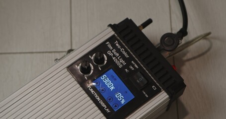 Fototapeta premium Studio LED light controller with screen showing color temperature and brightness settings