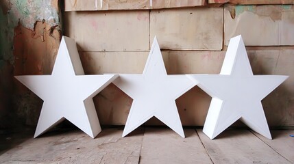 three stars made of white wood with led lights and christmas decorations inside
