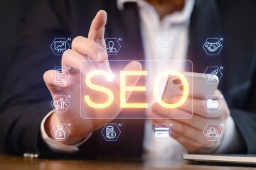 Fototapeta premium Person interacting with smartphone while focusing on digital marketing concepts related to SEO and artificial intelligence