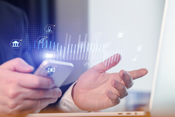 Man using smartphone for digital finance and technology tasks in modern office environment