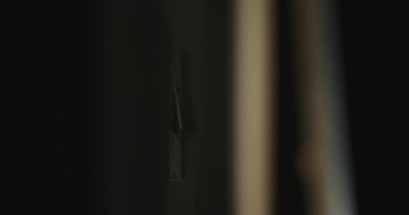 A human hand flips a switch on the white wall in the room - Powered by Adobe