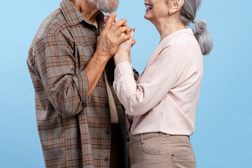 Senior couple holding hands and smiling, celebrating love, romance, and togetherness