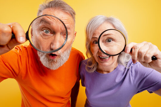 Mature couple finding something new and fascinating, expressing curiosity and surprise - Powered by Adobe
