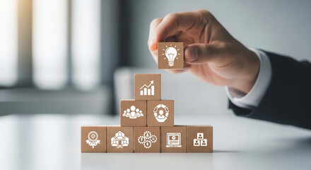 Building success a hand carefully places an idea atop a growing foundation