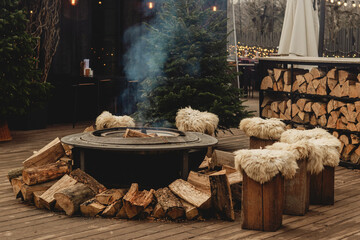 Cozy Outdoor Fire Pit with Wooden Stools and Winter Holiday Atmosphere