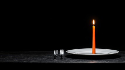 Orange Candle on Plate with Wine Glasses on Dark Table for Romantic Dinner Setting