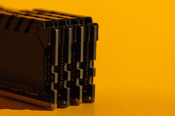 Macro view of stacked RAM module ends on yellow background. High quality photo