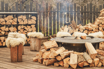 Cozy Outdoor Fire Pit with Wooden Stools and Winter Holiday Atmosphere