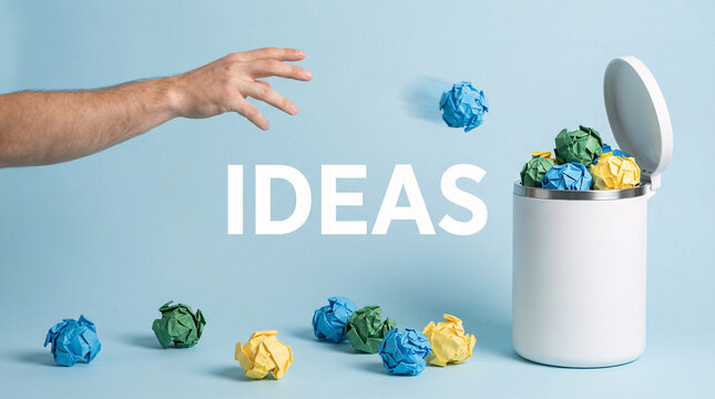 Hand throwing crumpled paper ideas into trash bin, failed creativity, brainstorming rejection and innovation concept.