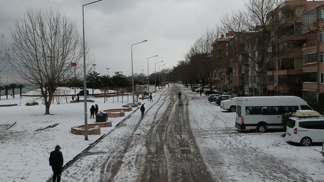 Footage of a snowy street in Taksim, Istanbul, capturing winter atmosphere and urban life during snowfall. Ideal for travel, winter, weather, and city lifestyle concepts.