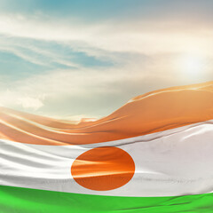 Niger national flag fluttering. The flag blowing in beautiful soft sky. Niger national flag for...