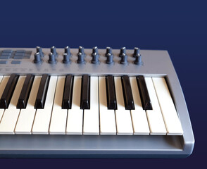MIDI Keyboard Controller for Electronic Music Production with many control knobs on dark blue background front view