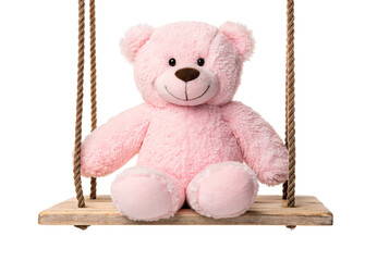 Pink plush teddy bear seated on wooden rope swing, isolated on a transparent background