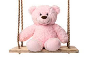 Pink plush teddy bear seated on wooden rope swing, isolated on a transparent background