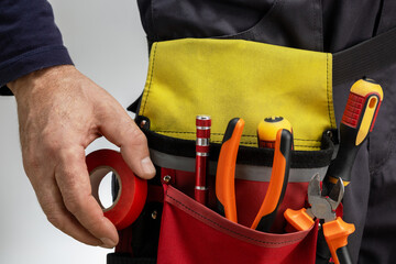 Close-up of tools belt on electrician worker. electrician services.