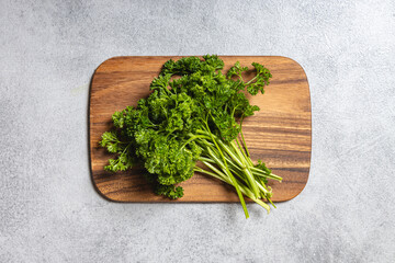 Curly Parsley on Wooden Board Surface