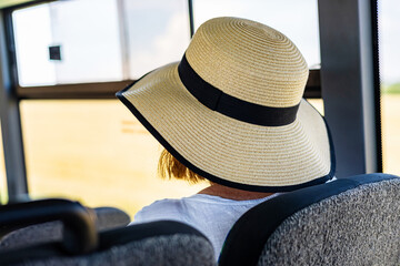 Woman Wearing Straw Hat On Bus