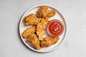 Top View Plate of Crispy Chicken Strips and Wings
