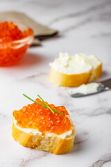 Sandwich with red caviar and soft cheese preparation process