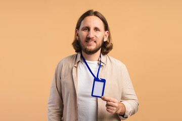 Happy man holding an empty ID card on a lanyard, ready for conference access