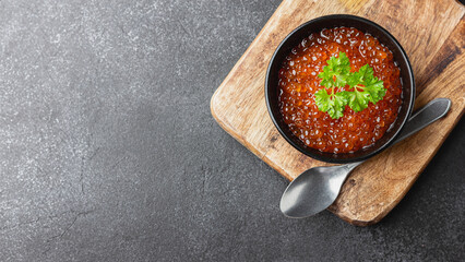 Red salmon caviar with parsley in a bowl