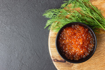 Red salmon caviar with dill in a bowl