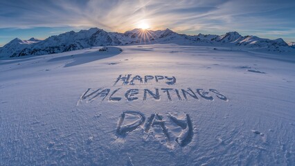 Happy Valentines Day Message Carved in Snow at Sunrise in Alpine Mountains.
