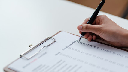 Person filling mental health checklist on clipboard with pen, psychological assessment, self evaluation, healthcare screening and wellbeing awareness concept.