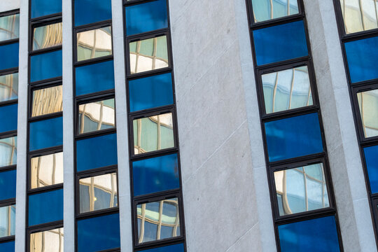 Modern urban architecture featuring office building facade with repetitive windows and geometry in a corporate contemporary city exterior