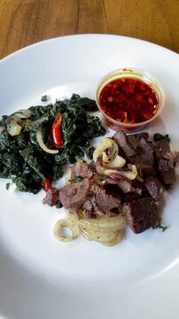 Beef Sei is Indonesia traditional smoked beef served with boiled cassava leaves