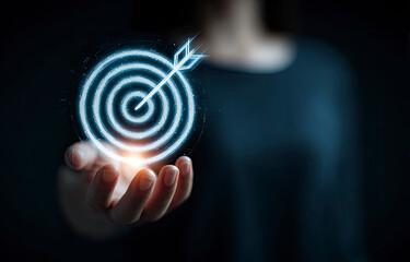 Hand Holding Glowing Digital Target Arrow