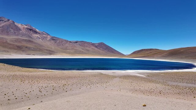 San Pedro de Atacama, Chile: Panorama footage of Lagunas Miscanti,  blue water lake near San Pedro de Atacama, Chile with Mi&ntilde;iques volcano in the background in south America on the Altiplano