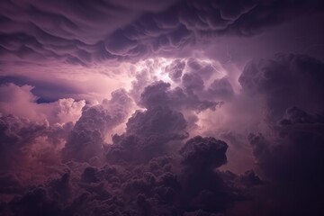 Purple cumulonimbus clouds illuminated by lightning during a dramatic sunset